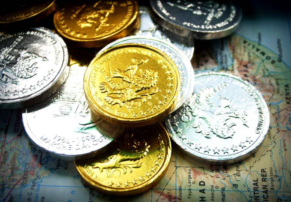 Gold And Silver Coins On World Map