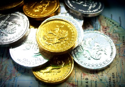 Gold And Silver Coins On World Map photo