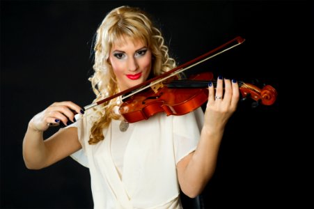 Woman In White Blouse Playing Violin photo