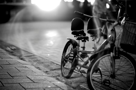 Tandem Bicycle On Sidewalk In Greyscale Photography photo