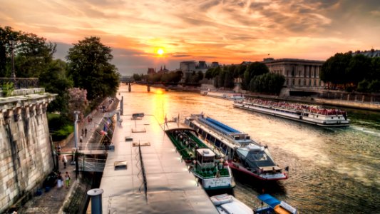 Boats On A River Next To Buildings photo