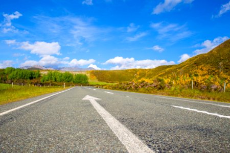 Road Passing Through Landscape Against Blue Sky