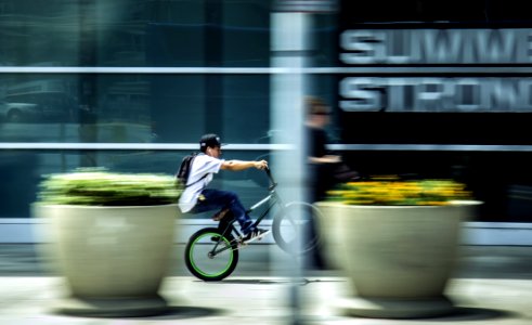 Man Riding Bicycle In City photo