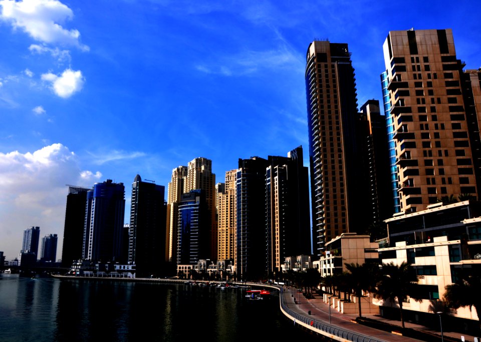 View Of Skyscrapers Against Cloudy Sky