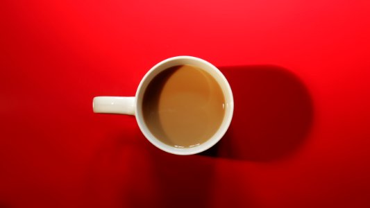 Coffee Cup With Coffee On Red Background photo