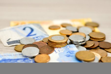 Bunch Of Bronze And Silver Coin And Banknote photo