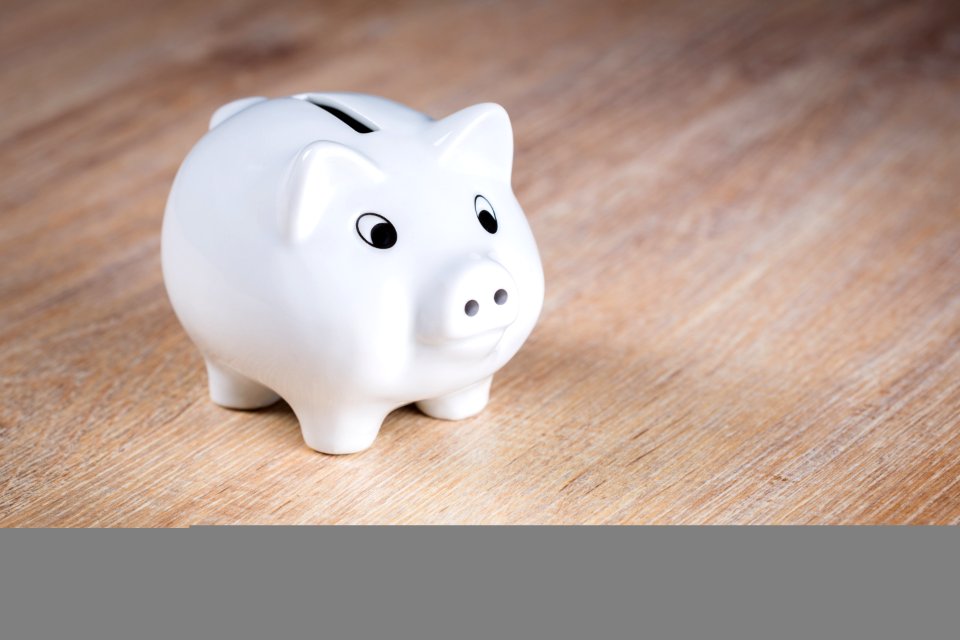 White Piggy Bank On Brown Wooden Surface