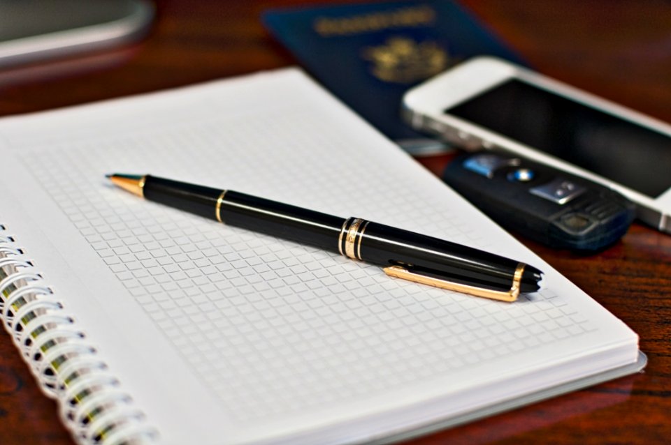 Black And Gold Twist Pen Near White Smartphone