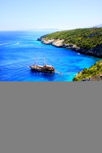 Brown And White Boat On Blue Seashore photo