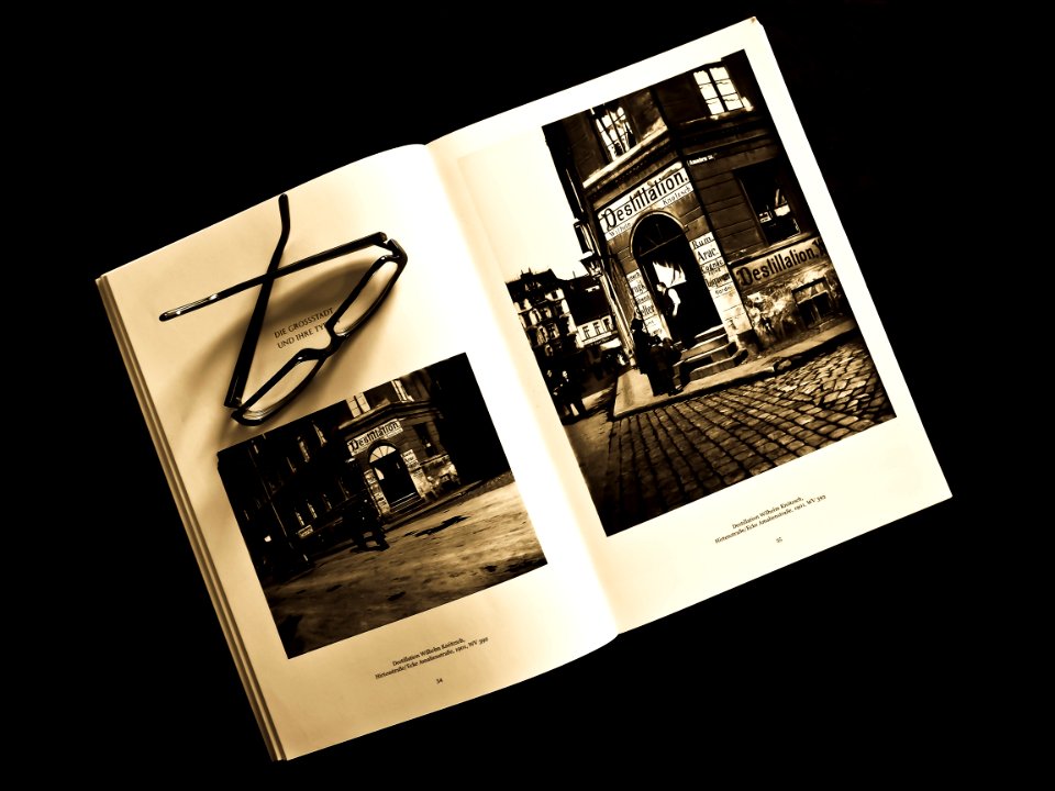 Black Framed Eyeglasses On White Photo Album
