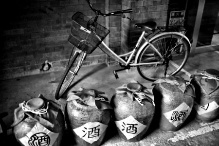 Grayscale Photography Of Dutch Bike Behind Jars photo