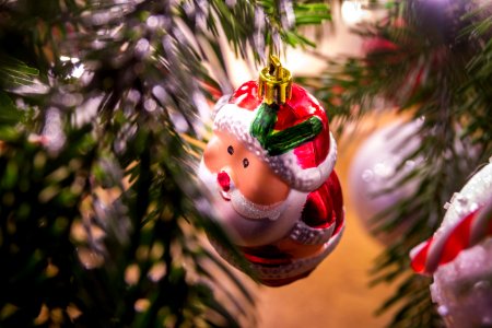 Santa Claus Ornament Hanging On Christmas Tree photo