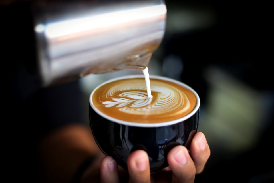 Close-up Of Woman Holding Coffee Cup At Cafe