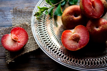 Sliced Plums On Silver Round Platter photo