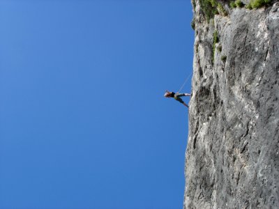 Man Standing On Rock Against Clear Blue Sky photo