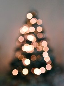 Defocused Image Of Illuminated Christmas Tree Against Sky photo