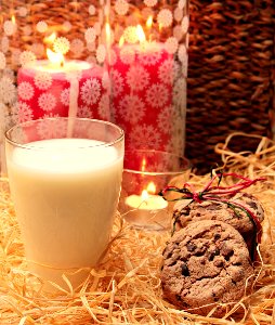Clear Glass Candle Holder Beside The Brown And Brown Cookie photo