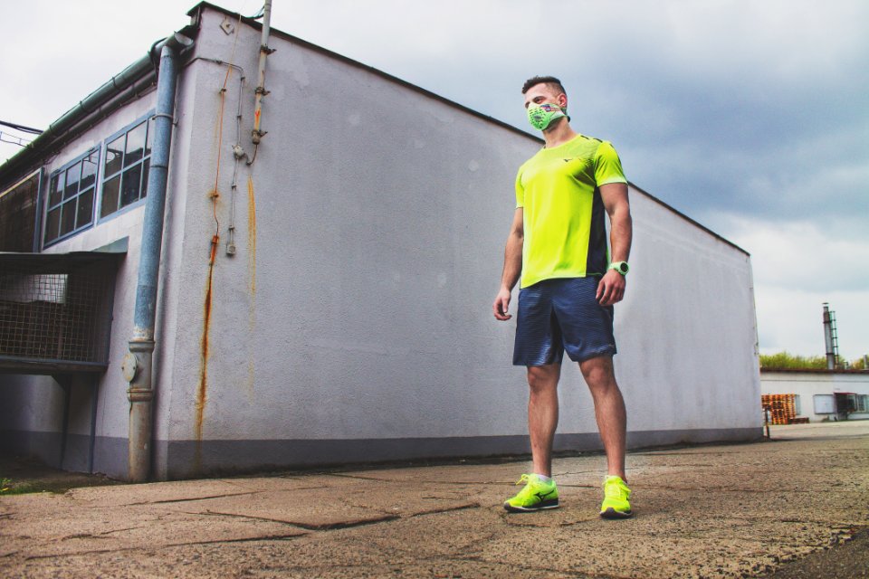 Man In Yellow T Shirt Standing Near The Wall photo