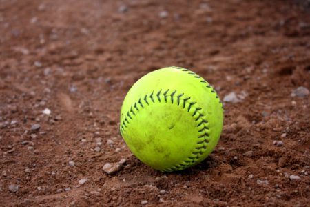 Yellow And Black Tennis Ball In Brown Soil photo