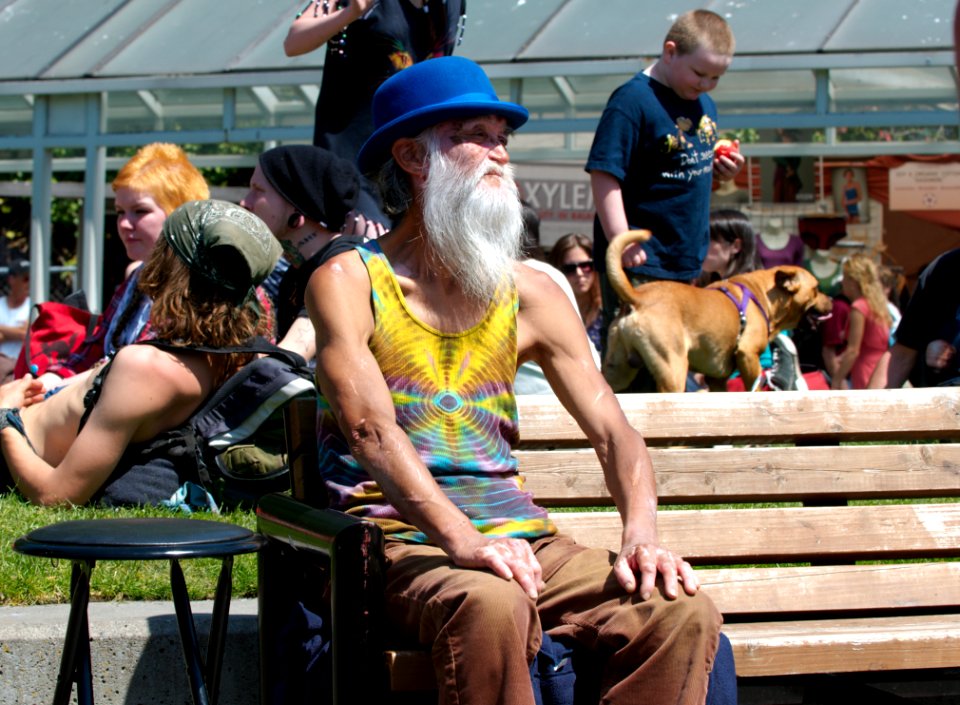 Elderly Man In Blue Hat On Bench