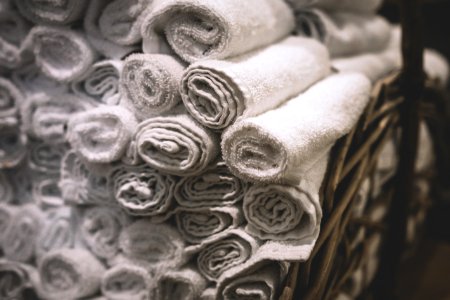 Stack Of Rolled White Bathroom Towels photo