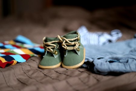 Babys Green And Beige Sneakers On Brown Textile photo
