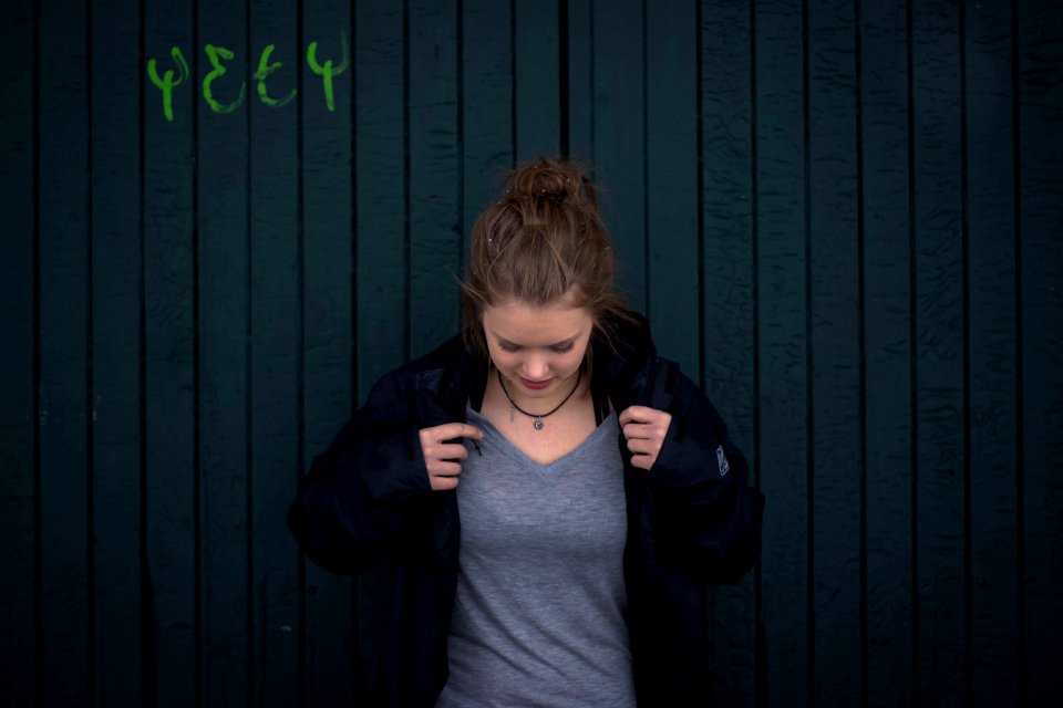Young Woman Adjusting Her Jacket