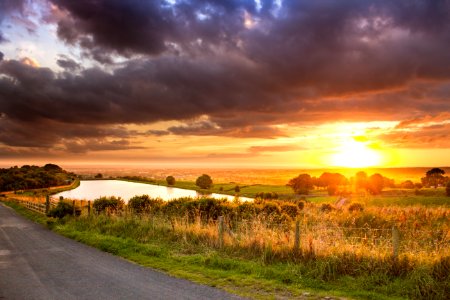 Scenic View Of Agricultural Field Against Dramatic Sky