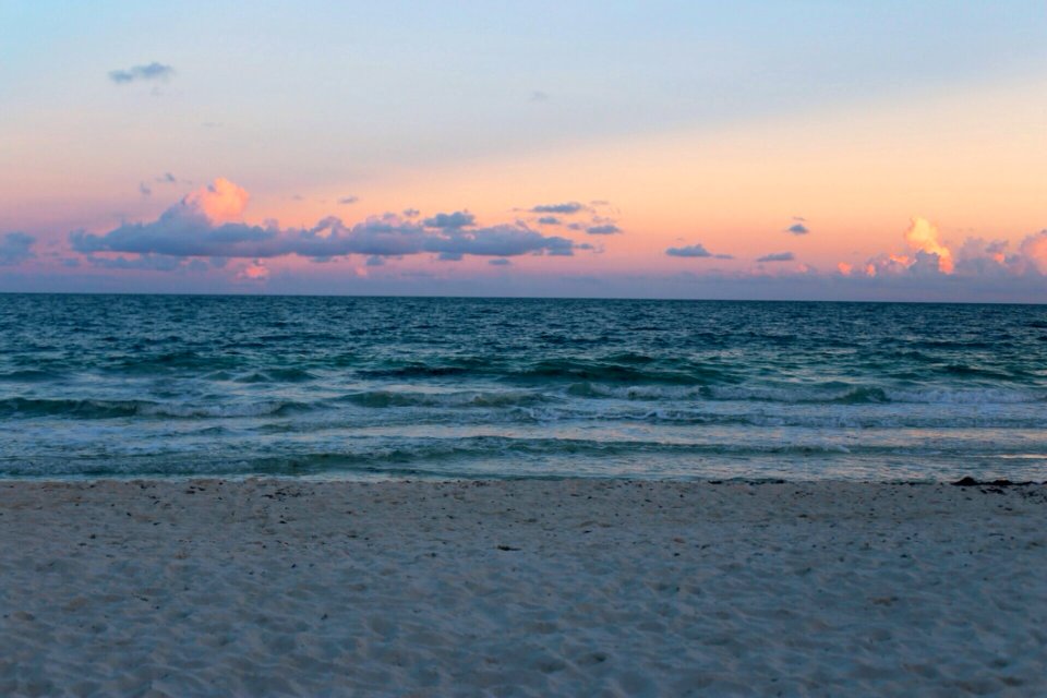 Ocean Waves On Beach At Sunset