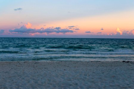 Ocean Waves On Beach At Sunset