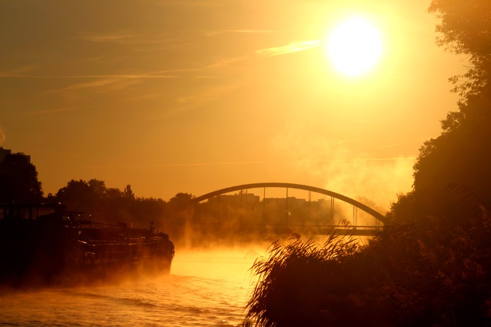 Sunset And Bridge Over River