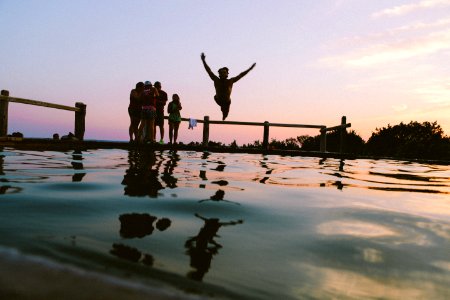 People Watching Man Dive Into Water