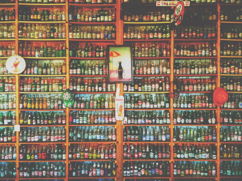 Collection Of Glass Soda And Beer Bottles On Shelves