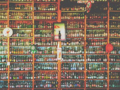 Collection Of Glass Soda And Beer Bottles On Shelves