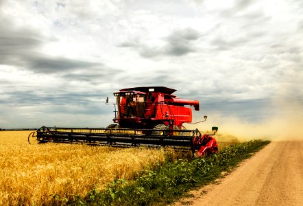 A harvesting combine kicks up dust during its work in field near the tiny town of Carpenter in southeast Wyoming's Laramie County. Original image from Carol M. Highsmith’s America, Library of Congress collection.