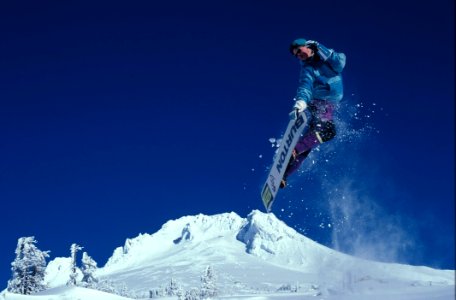 Man Snowboarding During Daytime photo
