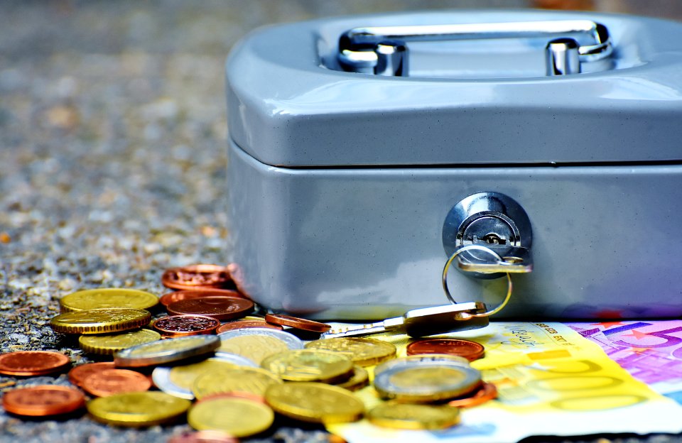 Coins And Bill Beside Coin Case