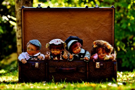 4 Porcelain Dolls In Brown Rectangular Box