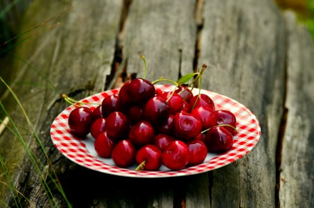 Cherry Fruits On White And Red Ceramic Round Plate photo