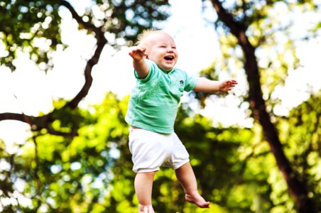 Young Baby Boy Jumping In Midair photo