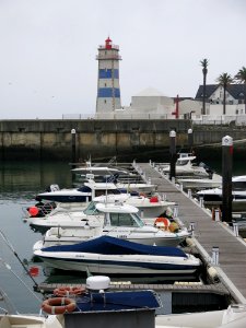 Lighthouse And Boats On Waterfront