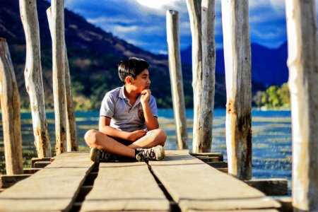 Boy On Wooden Pier photo