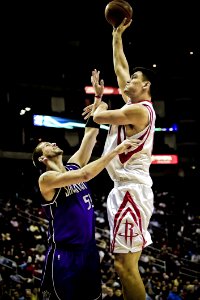 Yao Ming Holding Basketball On His Left Hand While Jumping