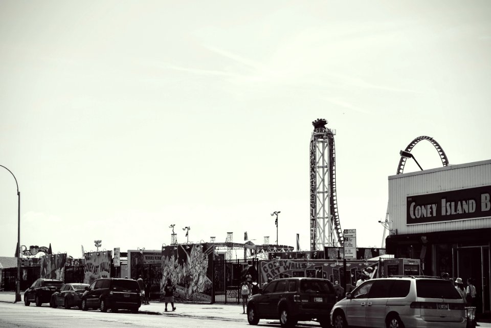 Grayscale Photo Of Car Parked Near Bulding