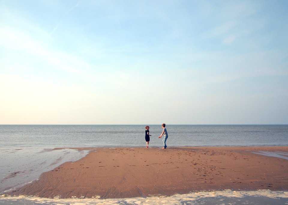 Two Children Playing On A Beach photo