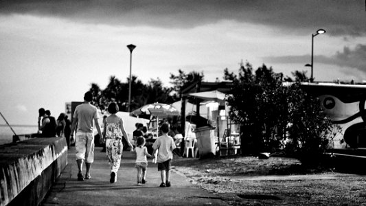 Family Walking Beside The Sea