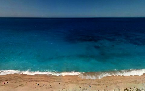 Turquoise Ocean Water By Beach photo