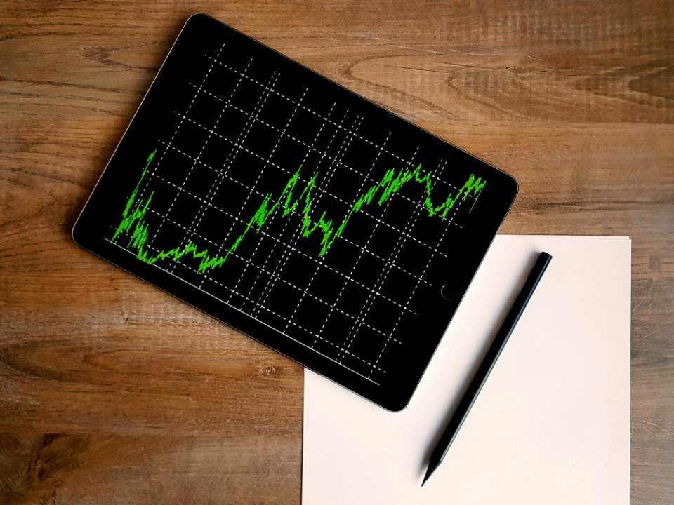 Space Grey Ipad Air With Graph On Brown Wooden Table