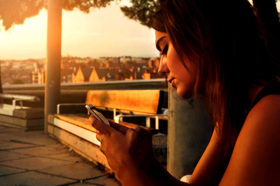 Woman With Black Dress Using A Smartphone