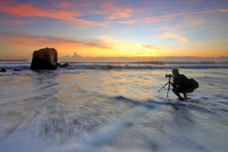 Photographer Shooting Sunset At The Sea photo